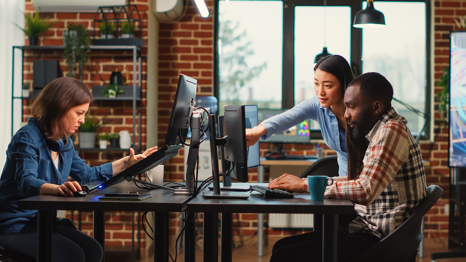 Lyric team members collaborating at their workstations in the headquarters